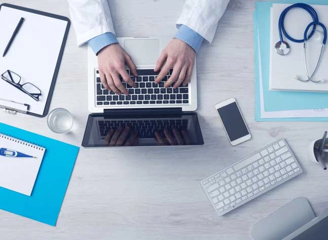 Medical Billing Summary By Medical Professional with Laptop, Mobile Phone, Stethoscope and Medical Documents