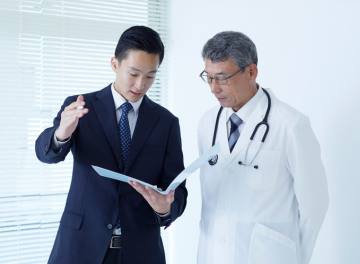 Attorney consulting with medical professional to review medical records for legal case