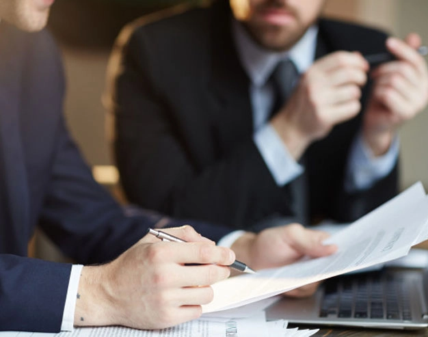 Legal team and medical consultants reviewing large-scale claimant records for a mass tort lawsuit